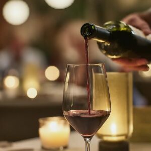 wine pouring from a bottle into a glass